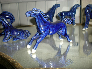 Ten piece set of cobalt blue ceramic horses